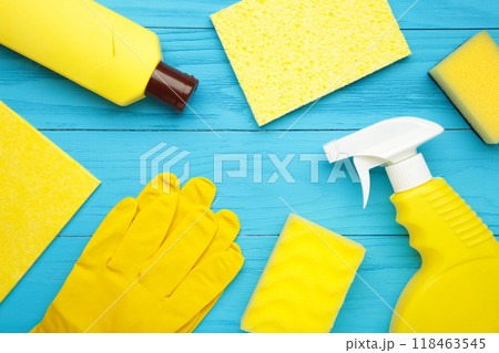 Cleaning Set. Yellow tools for cleaning. Cleaning agents, spray, rubber gloves on blue background. 118463545