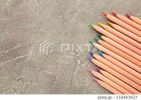 Colored pencils on the grey background. Top view. Colored pencils on the grey background. Top view. 118463627