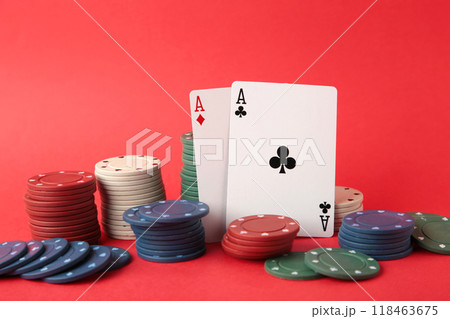 Poker chips and playing cards on red background 118463675