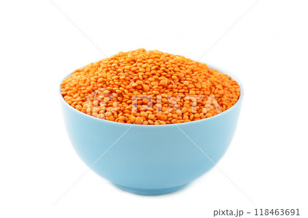 Red lentils in bowl isolated on a white background. Red lentils in bowl isolated on a white background. 118463691
