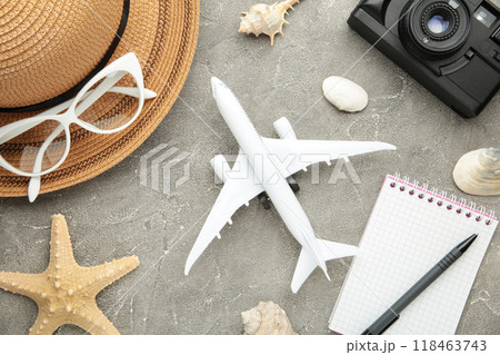 Planning summer holidays, tourism and trip vintage background. Travelers notebook with accessories on grey. Flat lay. Planning summer holidays, tourism and trip vintage background. Travelers notebook with accessories on grey. Flat lay. 118463743