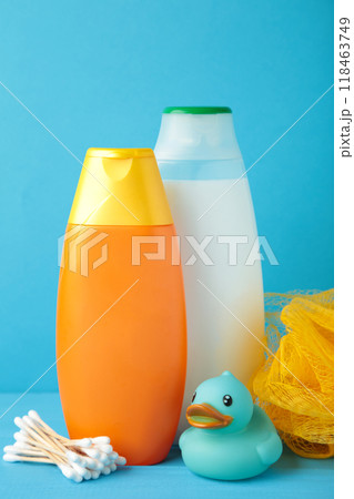 Toiletries baby on blue background. Baby shower gel. Vertical foto 118463749