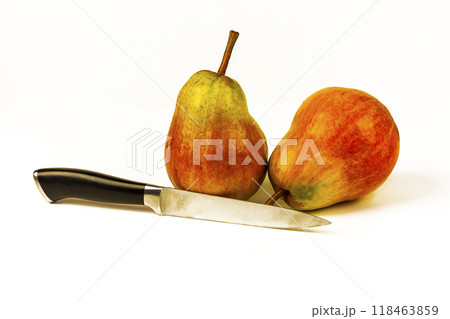 Two large ripe pears and a knife on a white background. On a white background two large ripe pears and a knife 118463859