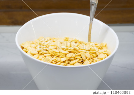 Cornflakes on a White Plate - Side View Cornflakes on a White Plate - Side View 118463892