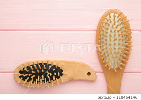 Set of comb and hairbrush on pink background with copy space Set of comb and hairbrush on pink background with copy space 118464146