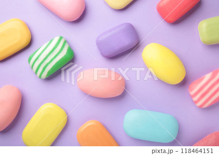 Different soaps in different soap dishes. A lot of solid soap for hygiene and cleanliness. Colorful soap and remnants are scattered on purple table. Different soaps in different soap dishes. A lot of solid soap for hygiene and cleanliness. Colorful soap and remnants are scattered on purple table. 118464151
