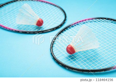 Shuttlecocks and badminton rackets on blue background. Badminton equipment Shuttlecocks and badminton rackets on blue background. Badminton equipment 118464156