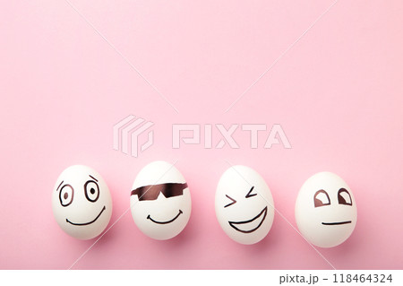 Funny Easter eggs with different emotions on his face on pink background. Easter composition. 118464324