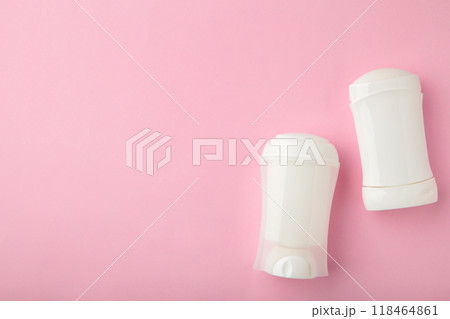 White antiperspirant deodorant on pink background. Skin care concept. copy space, top view White antiperspirant deodorant on pink background. Skin care concept. copy space, top view 118464861