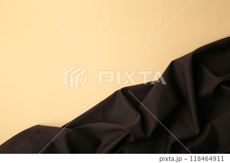 Brown satin fabric background on beige for your text 118464911