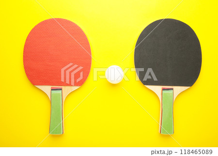 Ping pong rackets and balls on yellow background. Ping pong rackets and balls on yellow background. 118465089