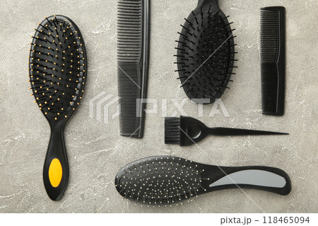 Hair tools, beauty and hairdressing concept - different brushes or combs on grey background 118465094