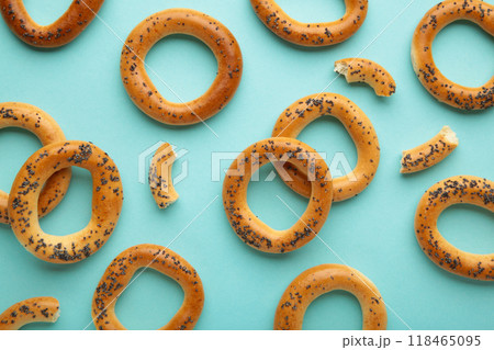 Whole bagel with poppy seeds on blue background 118465095