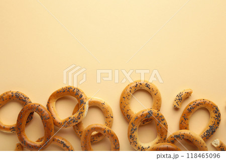 Whole bagel with poppy seeds on beige background with copy space 118465096
