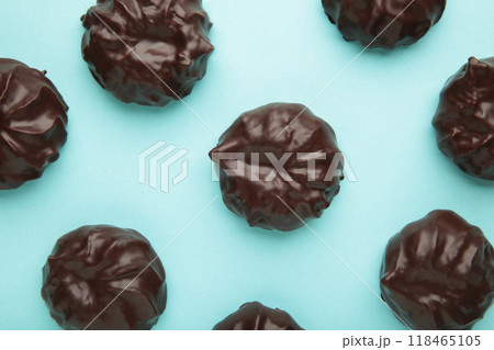 Chocolate covered marshmallows on blue background. Minimalism 118465105