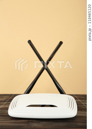Wireless Wi-Fi router on a beige background. Vertical photo 118465120