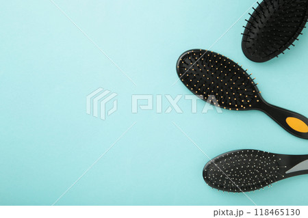 Hair tools, beauty and hairdressing concept - different brushes or combs on blue background Hair tools, beauty and hairdressing concept - different brushes or combs on blue background 118465130