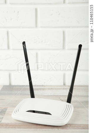 Wireless Wi-Fi router on a white background. Vertical photo 118465155