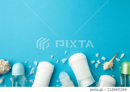 Deodorants for women and seashells on blue background with copy space 118465264