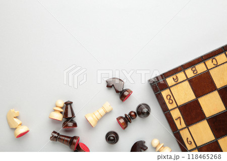 Symbol of competition. Chess board and chess figures on grey background top view copy space Symbol of competition. Chess board and chess figures on grey background top view copy space 118465268