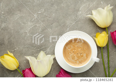 Cup of coffee with tulips on grey background with copy space. Cup of coffee with tulips on grey background with copy space. 118465281