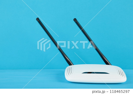 White wi-fi router with black antennas on blue background with copy space. Minimalism 118465297