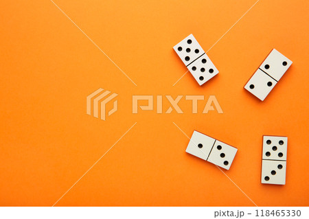 Domino pieces on the orange background with copy space. Game Domino pieces on the orange background with copy space. Game 118465330