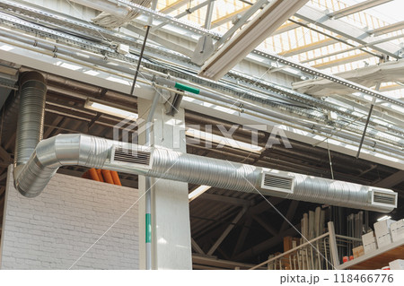 HVAC Ventilation Duct pipe with three grids, hanging under the ceiling inside industrial building. 118466776