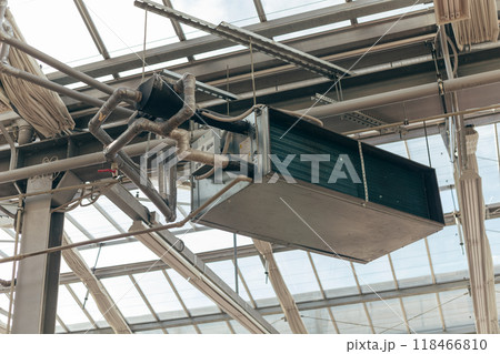 Industrial air conditioning handling unit suspended on frame construction under ceiling Industrial air conditioning handling unit suspended on frame construction under ceiling 118466810