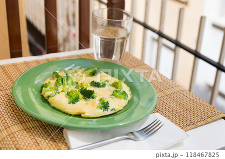 Wholesome breakfast. omelet with broccoli on green plate Wholesome breakfast. omelet with broccoli on green plate 118467825