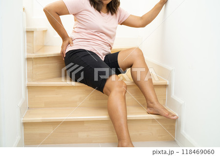 Asian lady fall down the stairs and pain at hip and waist because slippery surfaces. Asian lady fall down the stairs and pain at hip and waist because slippery surfaces. 118469060