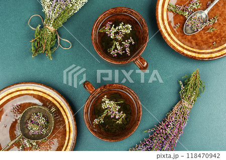 A cup of heather tea on a table. 118470942
