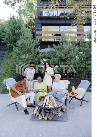 Friends have fun at a picnic, sing songs, dance, drink wine Friends have fun at a picnic, sing songs, dance, drink wine 118471264