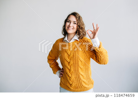 Confident Woman Showing OK Gesture. Smiling, Happy Model Gives Recommendation with Hand Sign - 118474659