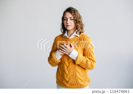 Grateful Young Woman: Expressing Happiness and Thankfulness - Hands on Chest, Mental Balance - 118474661