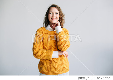 Young Woman Student Contemplates Future - Dreamy, Smiling, Hand on Chin - Reflecting on Ideas and 118474662
