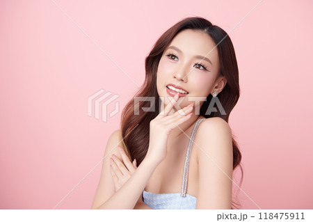 Beautiful young asian woman with clean fresh skin on pink background, Face care, Facial treatment, Cosmetology, beauty and spa, Asian women portrait. Beautiful young asian woman with clean fresh skin on pink background, Face care, Facial treatment, Cosmetology, beauty and spa, Asian women portrait. 118475911
