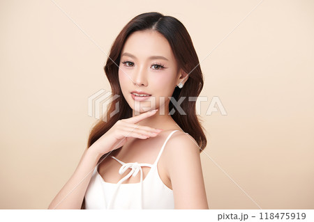 Beautiful young asian woman with clean fresh skin on beige background, Face care, Facial treatment, Cosmetology, beauty and spa, Asian women portrait. 118475919