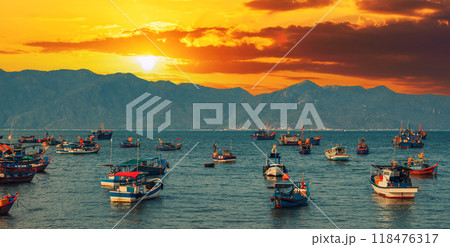 Vietnamese traditional fishing boats in sea at marina at sunset in summer Vietnamese traditional fishing boats in sea at marina at sunset in summer 118476317