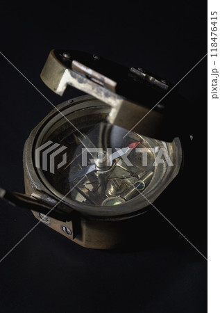 Antique bronze emblem compass (Old compass) on dark background. Antique bronze emblem compass (Old compass) on dark background. 118476415