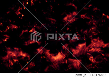 Bright scarlet smoldering embers of campfire in dark 118476886