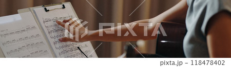 Observing Sheet Music During a Musical Rehearsal Observing Sheet Music During a Musical Rehearsal 118478402