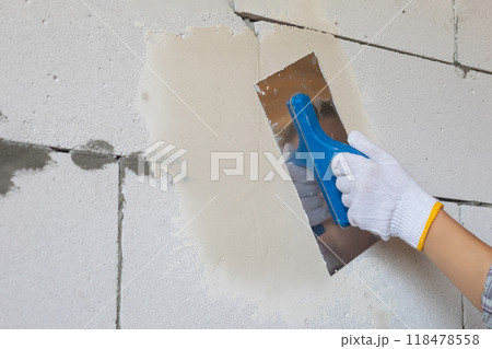The concept of leveling walls using a trowel. 118478558