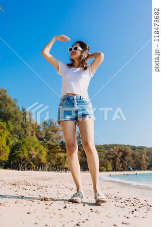 Cheerful woman walking along the beach and clear sky. 118478682