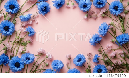 Bright blue and pink flowers arranged artistically on a soft pink background for spring celebrations 118479360