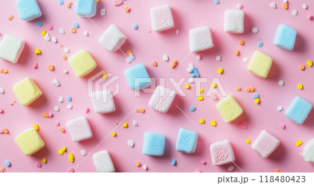 Colorful marshmallows and sprinkles on a vibrant pink surface for a festive treat 118480423