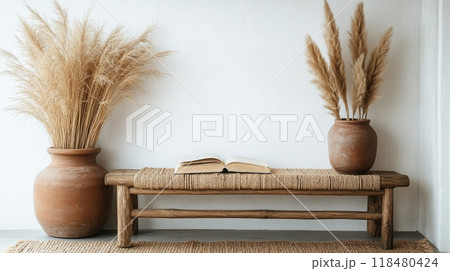 Cozy reading nook featuring a rustic bench, plants, and natural light streaming in 118480424