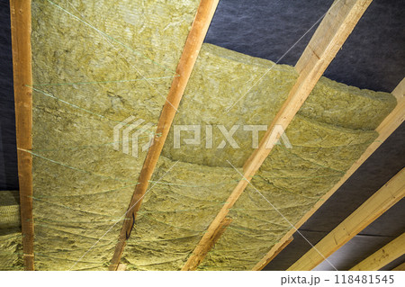 Thermal insulation mineral rock wool installation at the new building attic ceiling Thermal insulation mineral rock wool installation at the new building attic ceiling 118481545