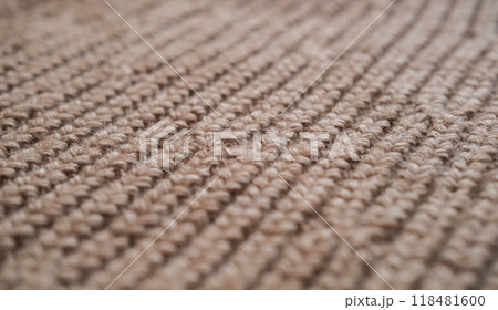 Close-up of the texture of knitted woolen fabric in light brown color 118481600