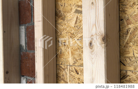 Construction of wood frame walls of a new country house site. Unfinished construction work inside. 118481988